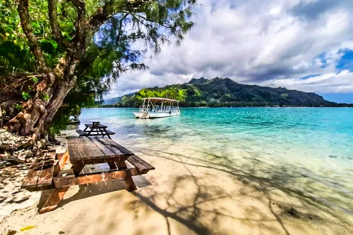 a wooden bench sitting next to a body of water
