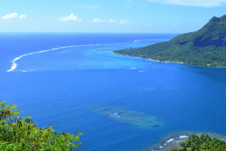 a body of water with a mountain in the background
