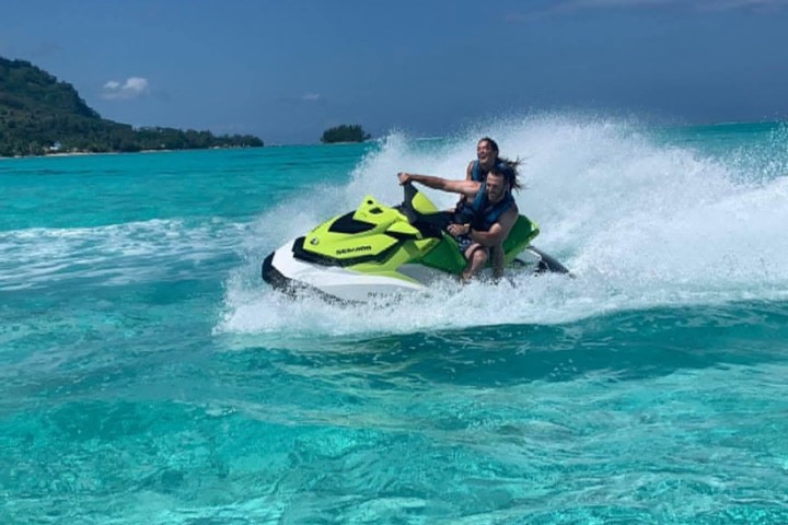 a man riding a wave on top of a body of water