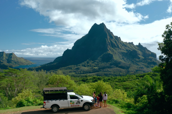 a truck is parked on the side of a mountain