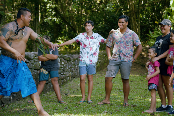 a group of people that are standing in the grass