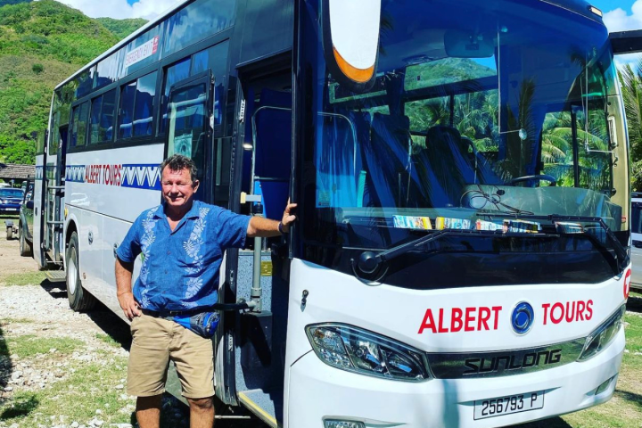 a group of people standing in front of a bus