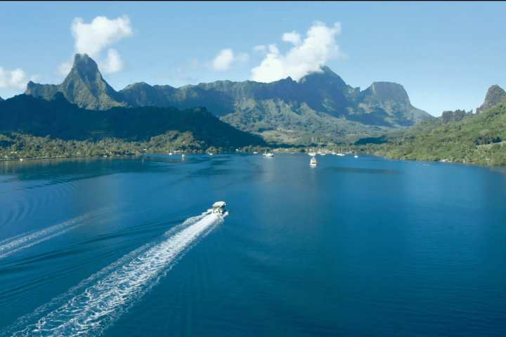 a large body of water with a mountain in the background