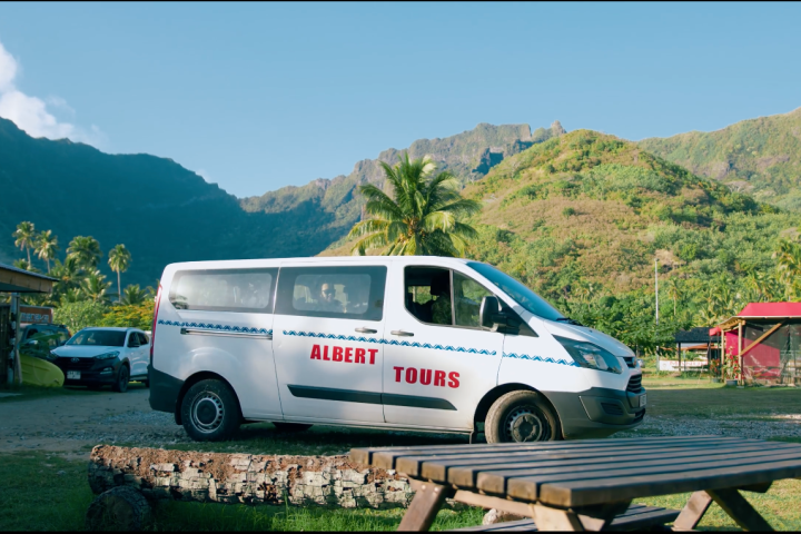 a truck is parked in front of a mountain